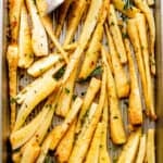overhead shot of a baking sheet with roasted parsnips