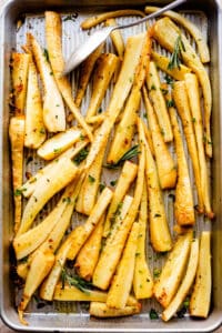 overhead shot of a baking sheet with roasted parsnips