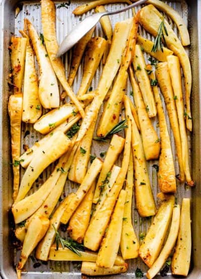 overhead shot of a baking sheet with roasted parsnips
