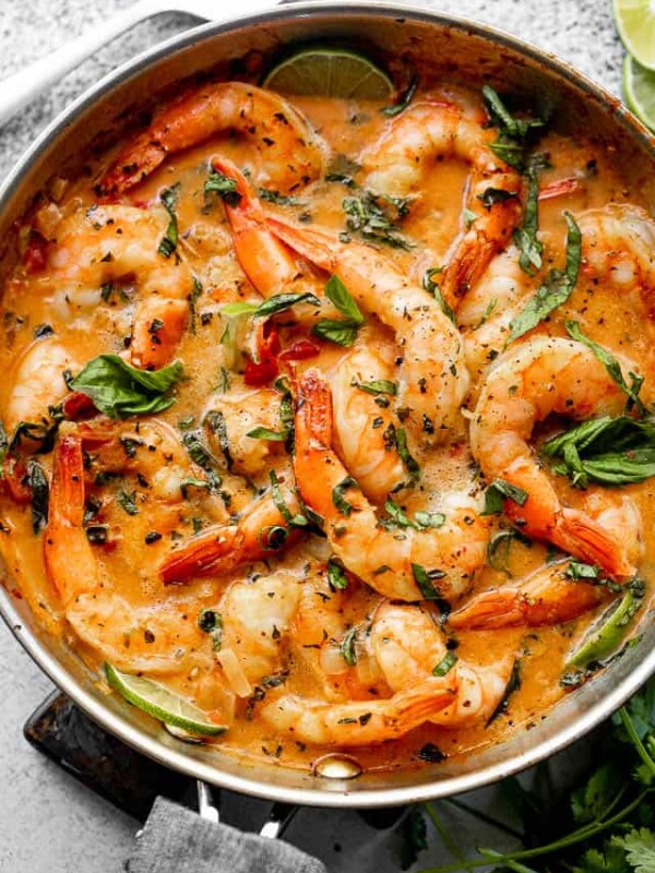 wide overhead shot of shrimp in a skillet with coconut sauce