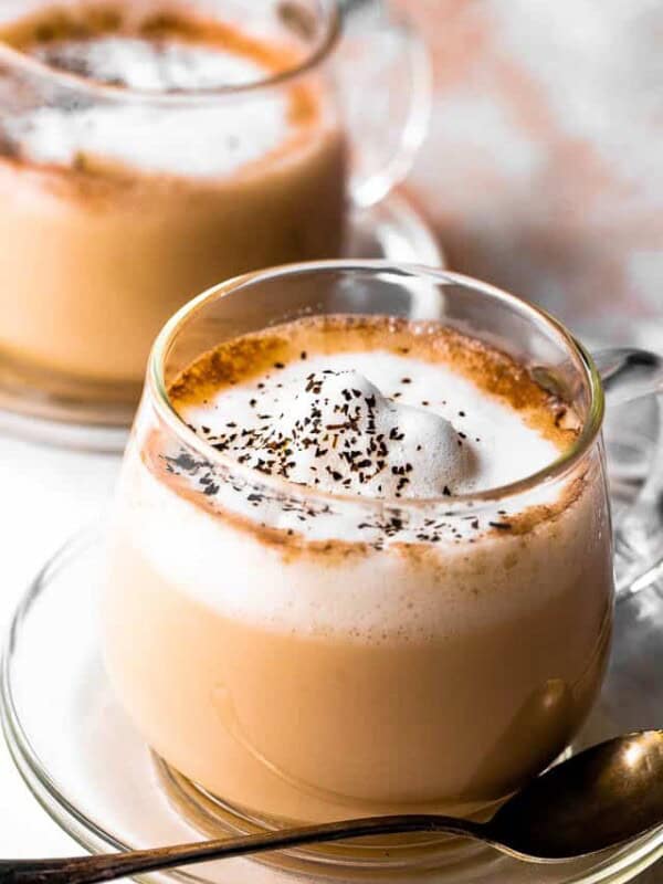 side shot of london fog tea topped with frothed milk and lavender leaves