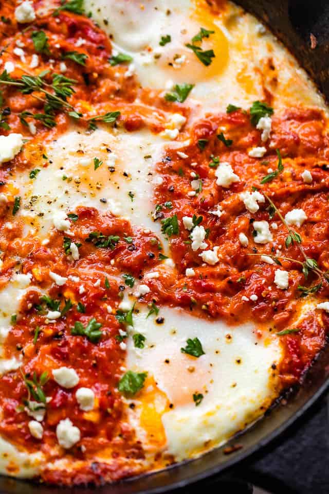 close-up overhead shot of macedonian shakshuka with ajvar in a cast iron skillet