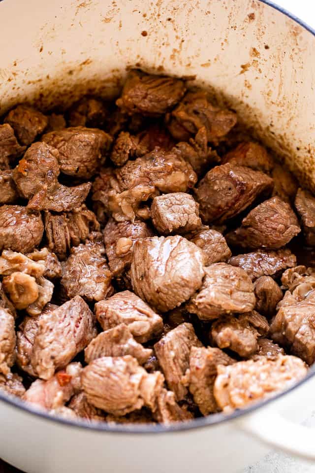browning cubed chuck roast in a dutch oven