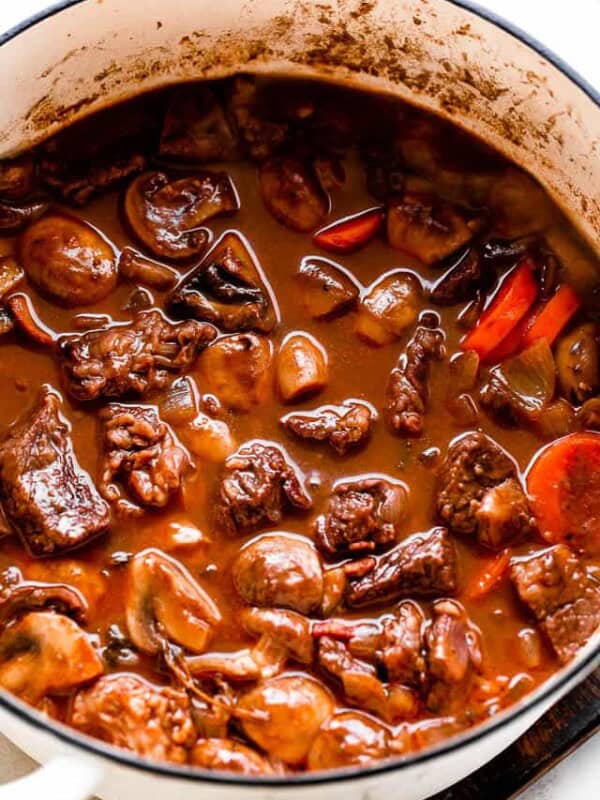 cooking Beef Bourguignon in a white dutch oven