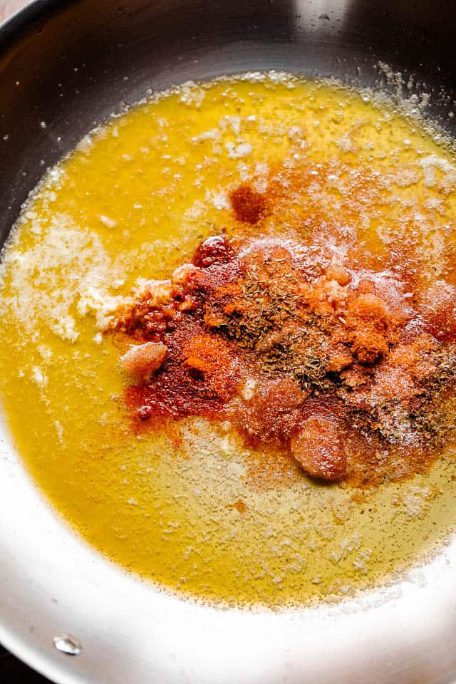 melting butter and adding cajun seasonings in a skillet