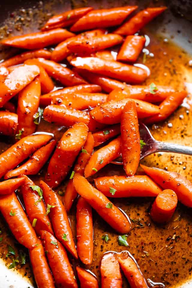 close up shot of roasted carrots in cajun butter sauce