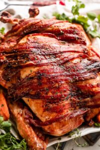 overhead shot of a roasted turkey covered with bacon