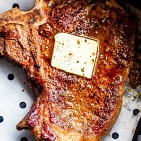 overhead picture of cooked steak topped with a pat of butter