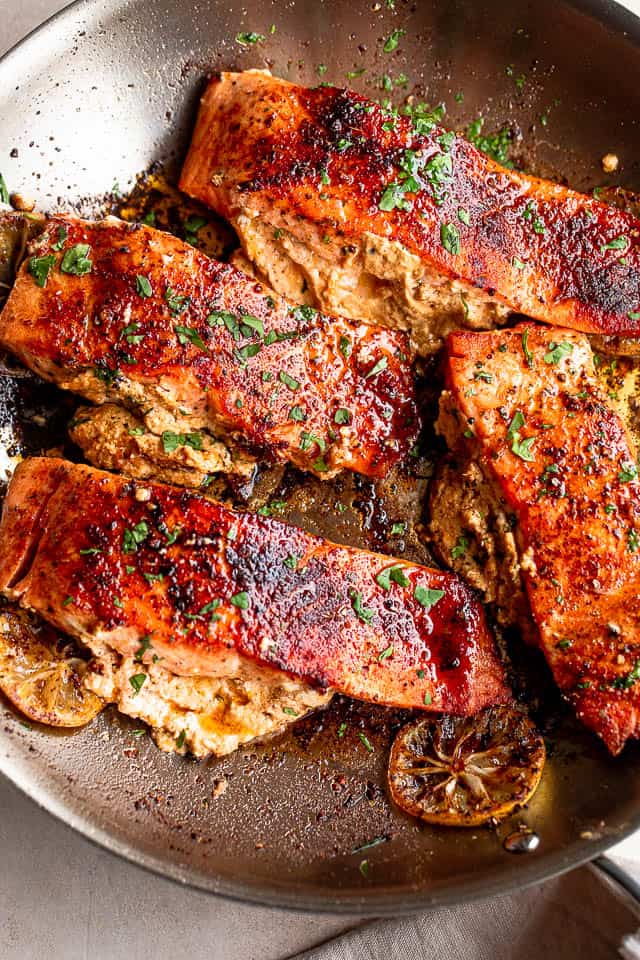 overhead shot of four salmon fillets stuffed with creamy cajun filling