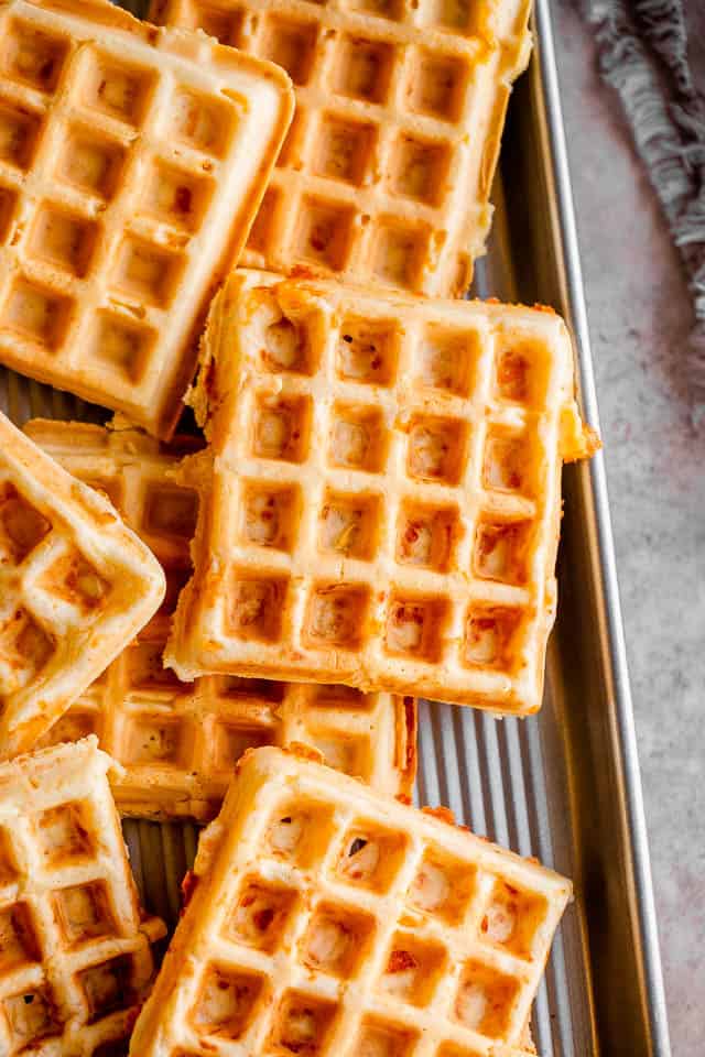 overhead shot of low carb waffles (chaffles) laid out on a silver baking sheet