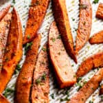 roasted sweet potato wedges garnished with chopped parsley