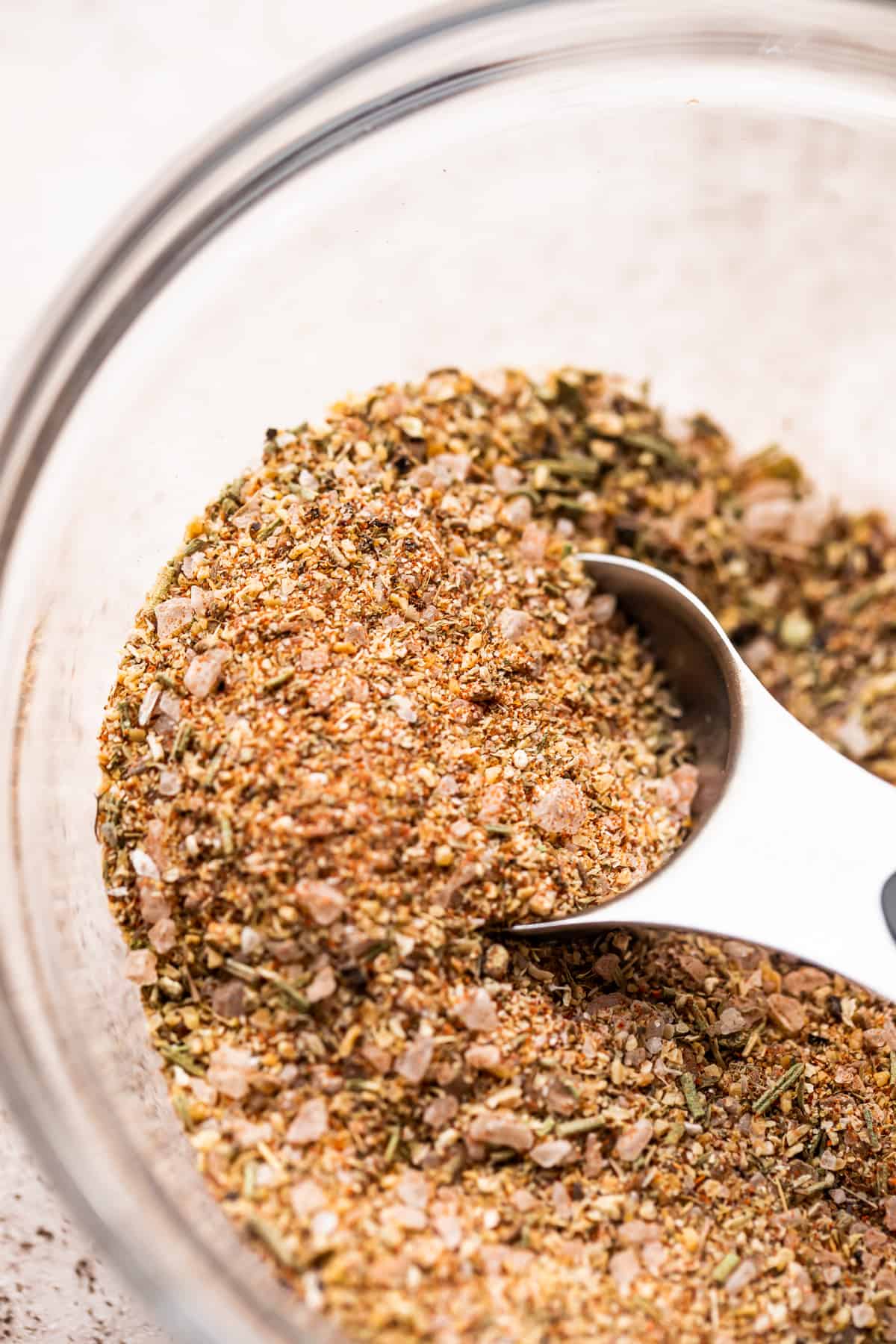 A bowl with steak seasoning and a measuring spoon