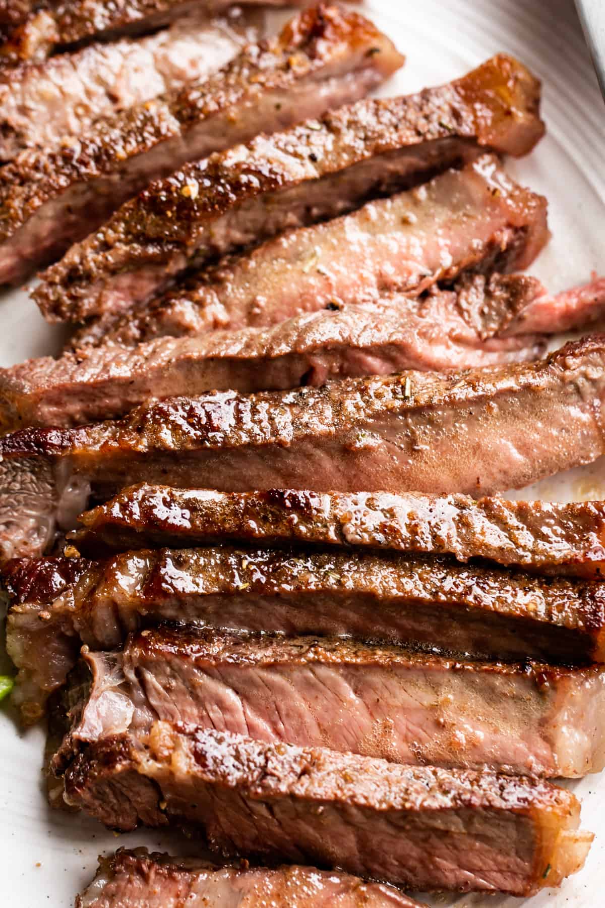 Sliced steak on a white plate