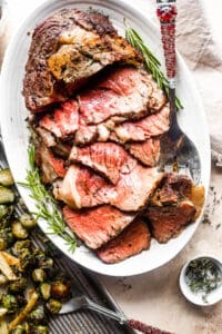 overhead shot of boneless prime rib cut in slices and served on a platter