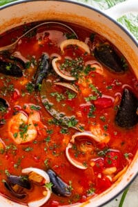 overhead close up photo of cioppino in a dutch oven