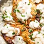 overhead photo of fried pork chops topped with mushroom cream marsala sauce