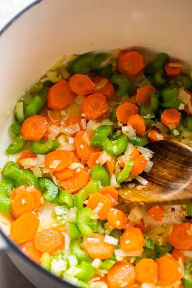 sauteeing celery and carrots in a dutch oven