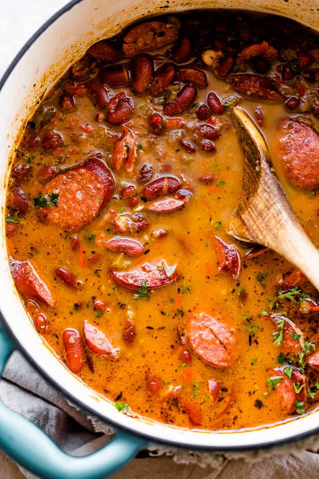 Louisiana Red Beans and Rice is a dish prepared with spicy Andouille sausage and tender red beans served over rice! cooked red beans and sausage in a dutch oven
