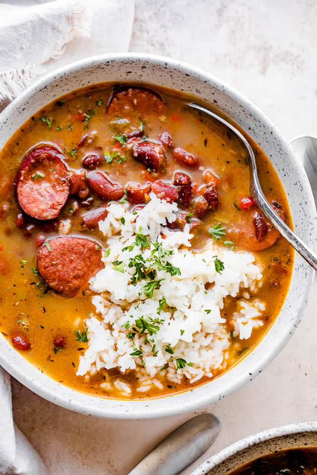 brothy red beans and andouille sausage topped with rice and parsley