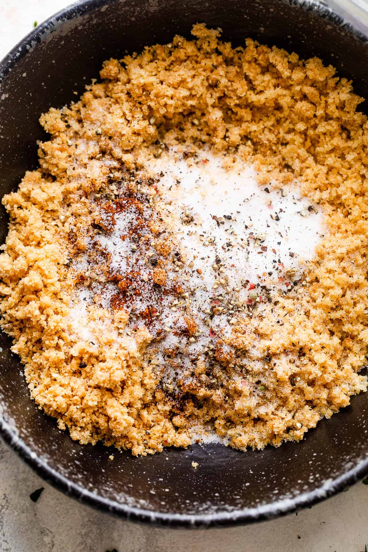 seasoned pork rind crumbs in a black bowl