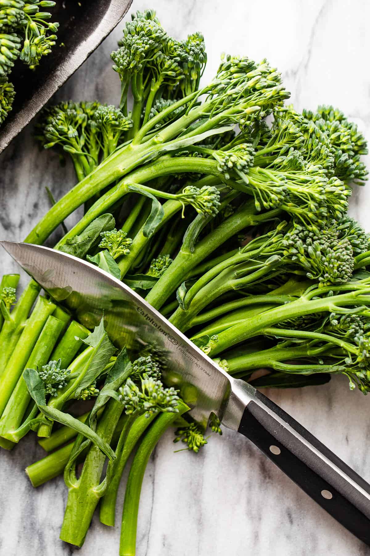 trimming broccolini with a knife