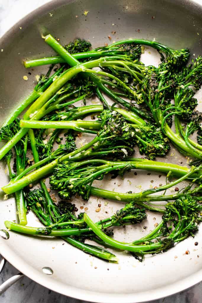 sauteeing broccolini in a skillet