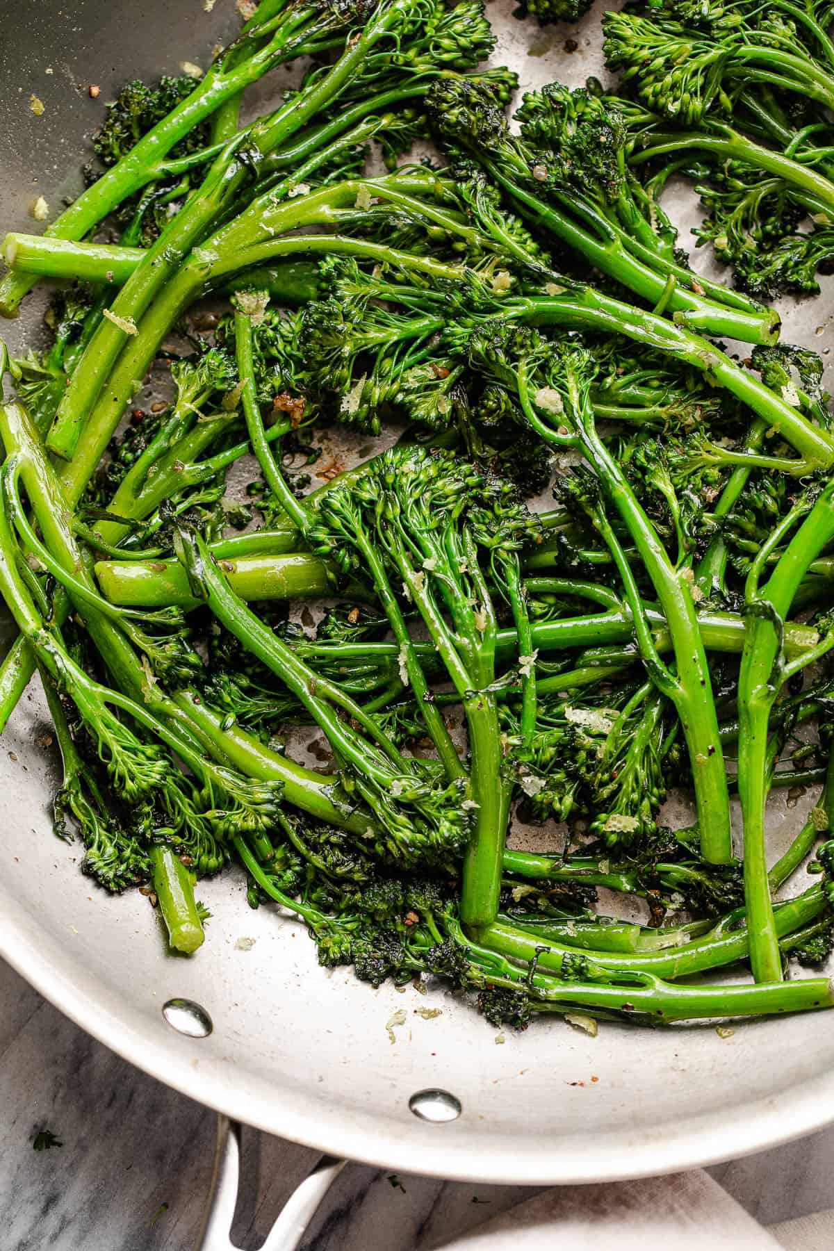 cooking broccolini in a skillet