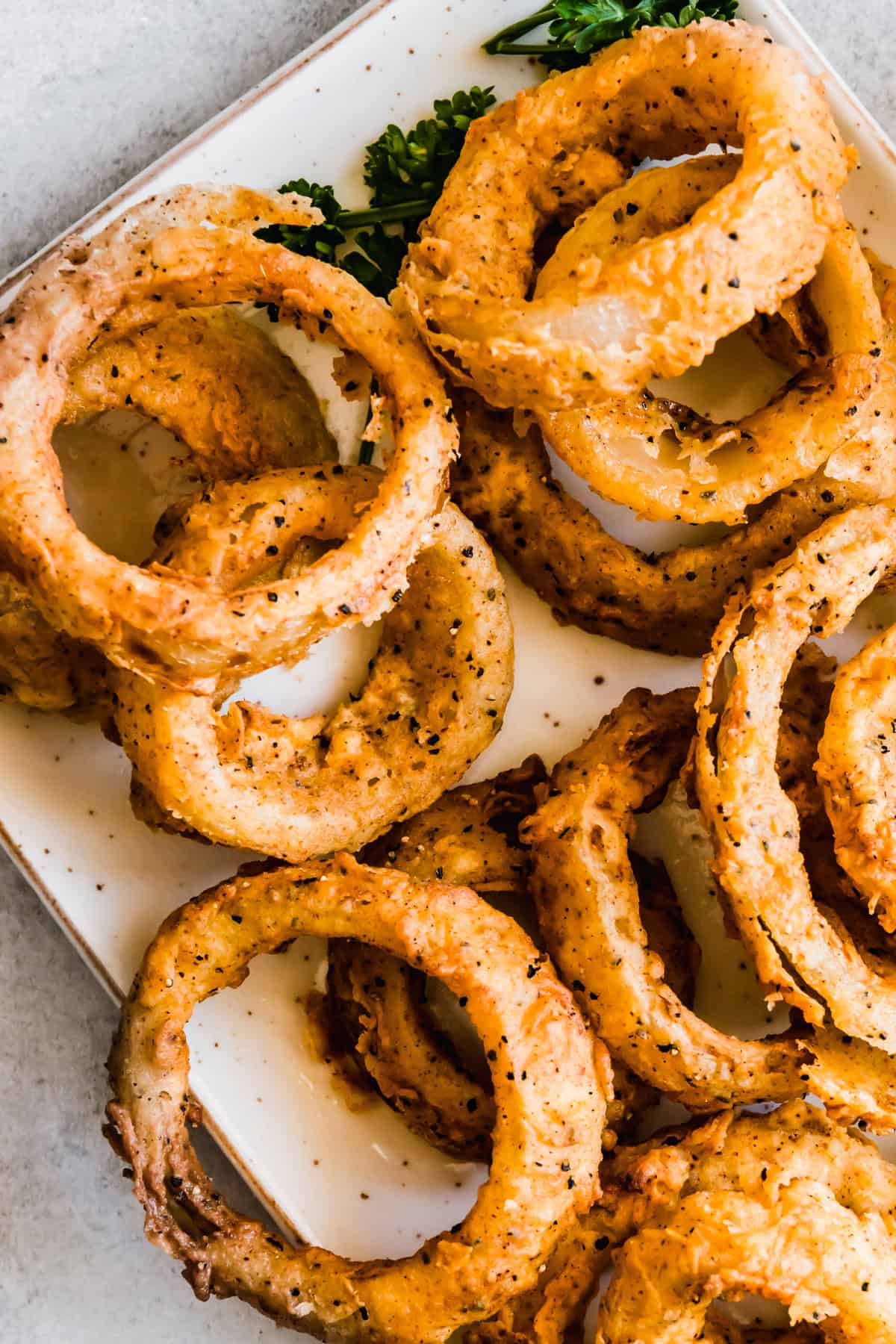 Close-up of homemade onion rings served on a plate.