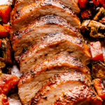 Close-up view of slice Honey Glazed Pork Loin with roasted vegetables