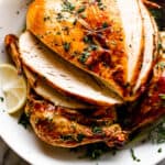 whole roast chicken in a white bowl