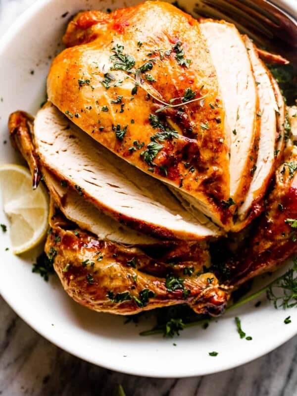 whole roast chicken in a white bowl