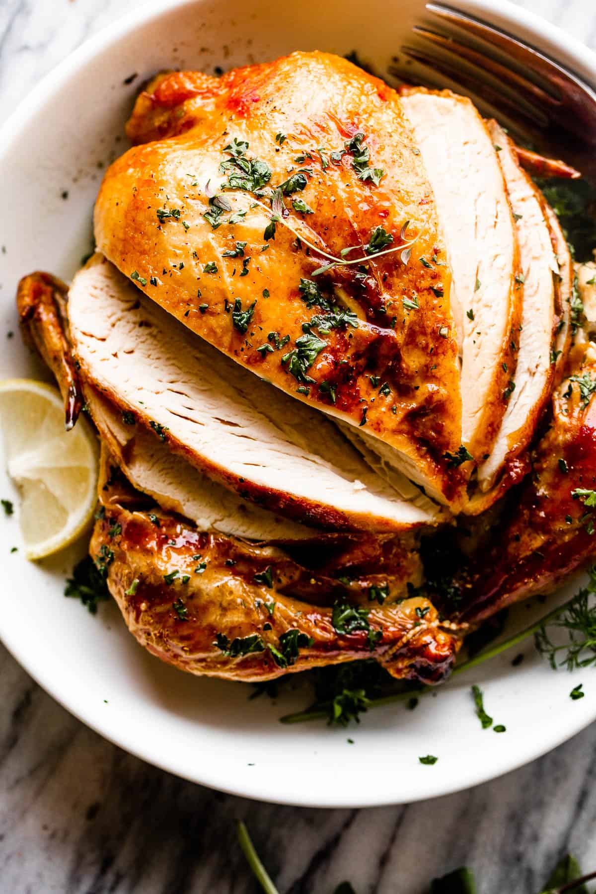 whole roast chicken in a white bowl