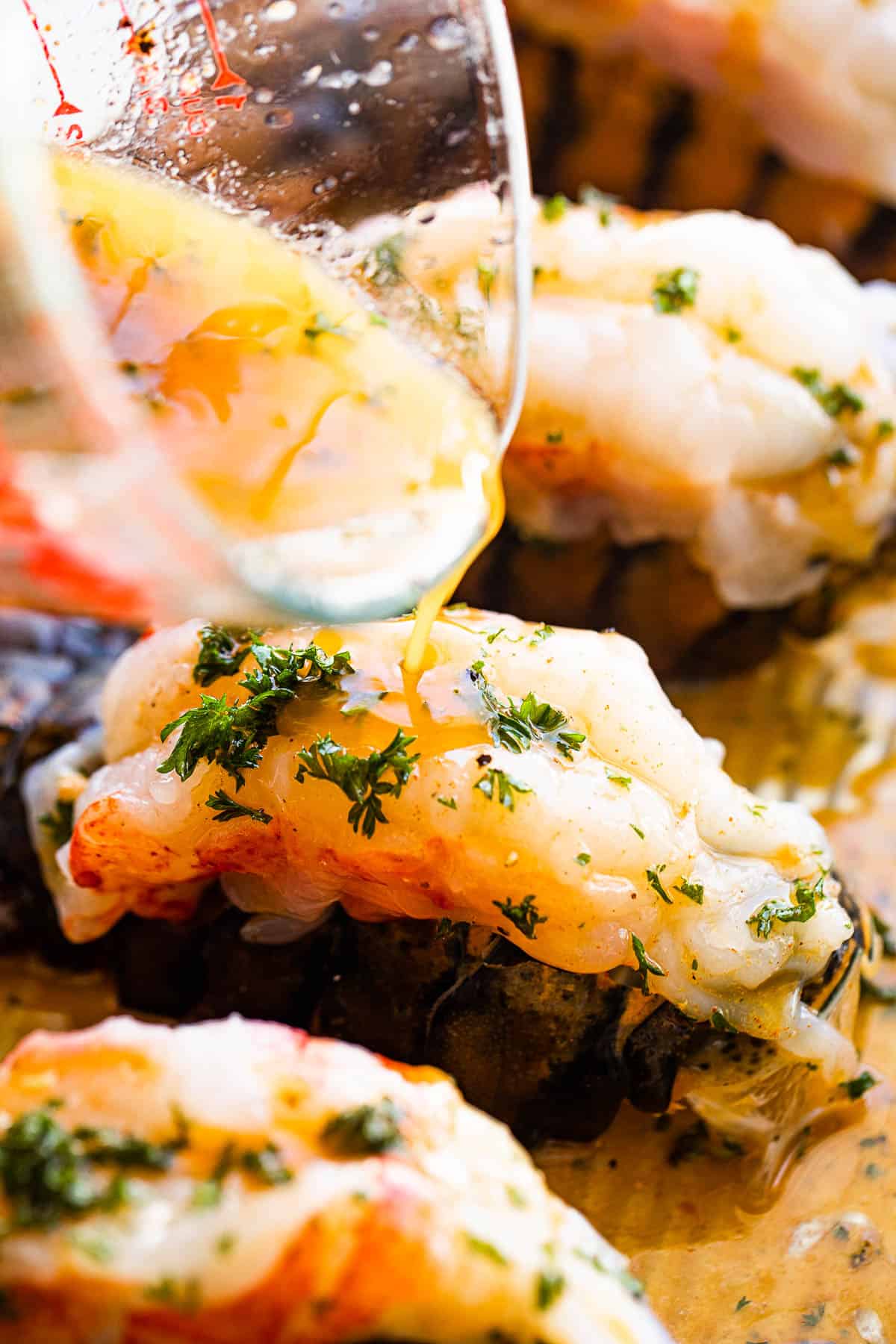 Garlic Butter Sauce Being Poured Over the Lobster Meat