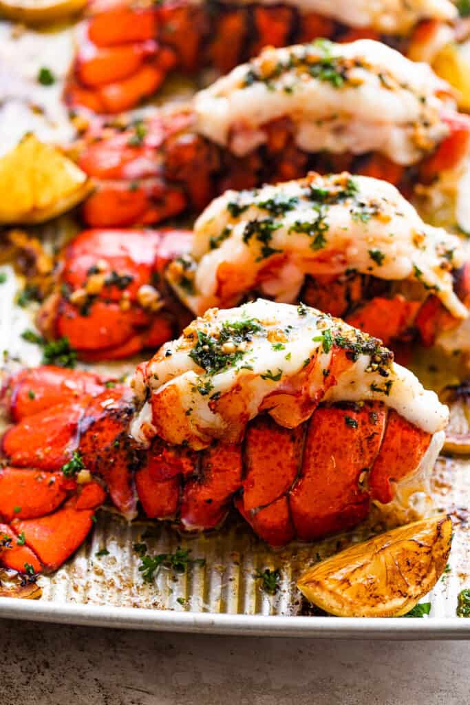 A Close-up Shot of a Baked Lobster Tail Next to a Lemon Wedge