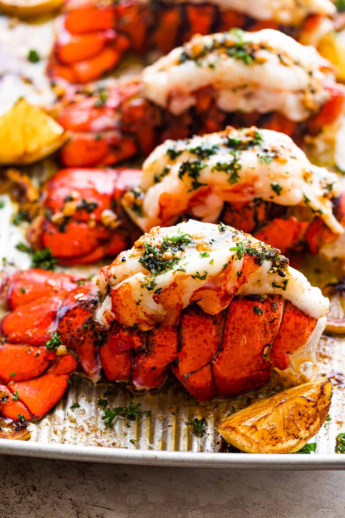 A Close-up Shot of a Baked Lobster Tail Next to a Lemon Wedge