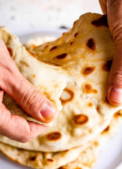 tearing naan bread with hands