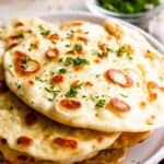 stacked naan bread served on a plate