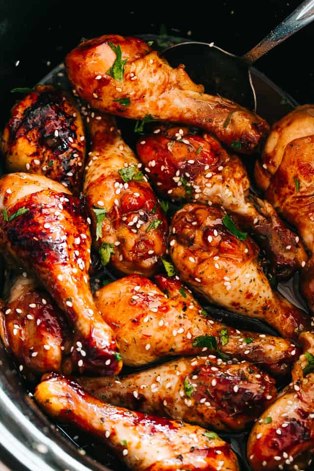 Slow Cooker Asian Glazed Chicken topped with sesame seeds and green onions