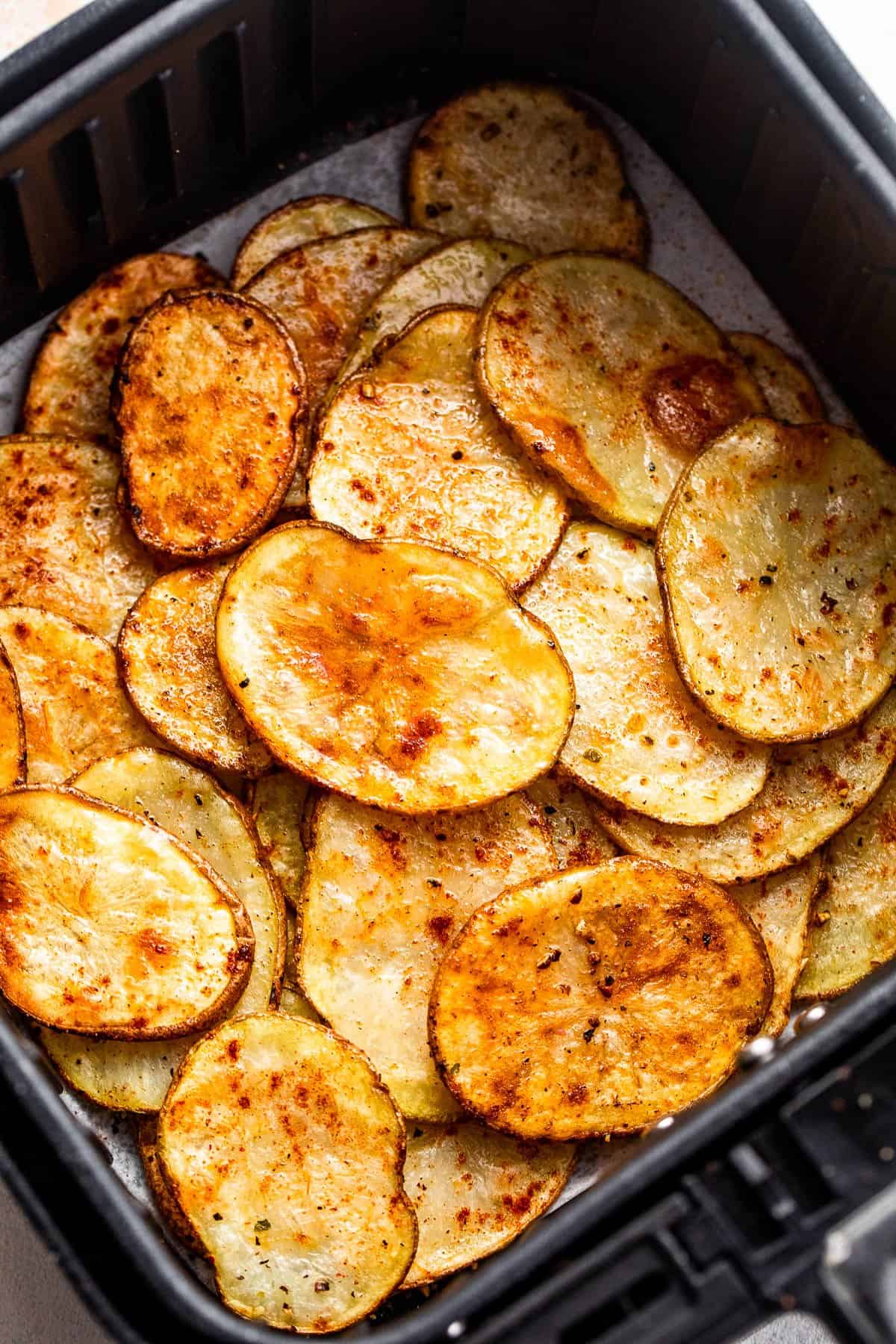 baked potato chips in an air fryer basket