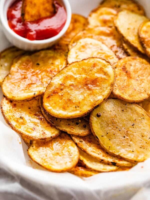 serving air fryer potato chips with a small bowl of ketchup on the side