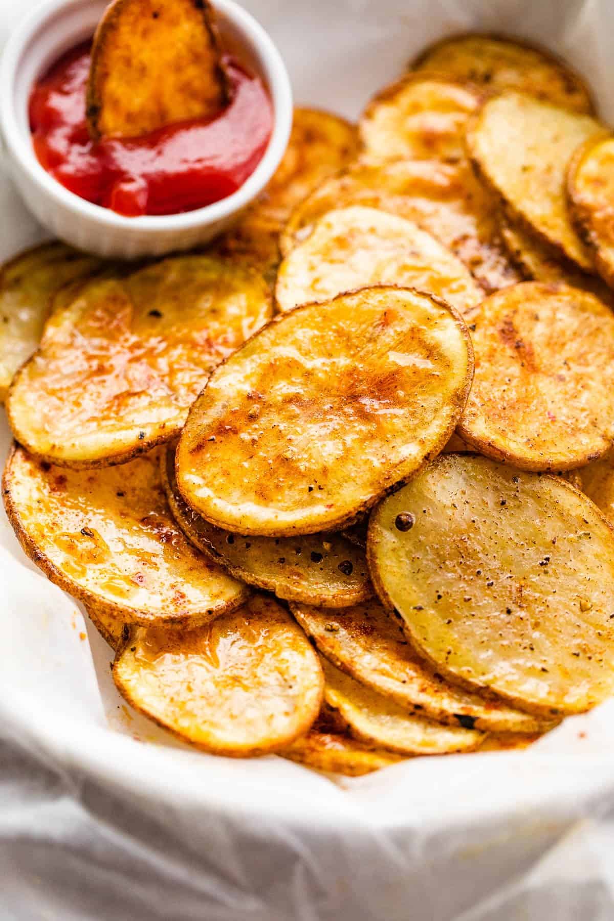 serving air fryer potato chips with a small bowl of ketchup on the side