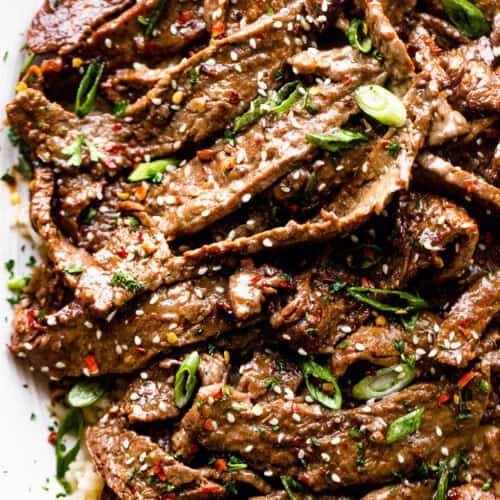 slices of korean beef bulgogi topped with green onions