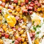 mixing through corned beef hash with a spoon