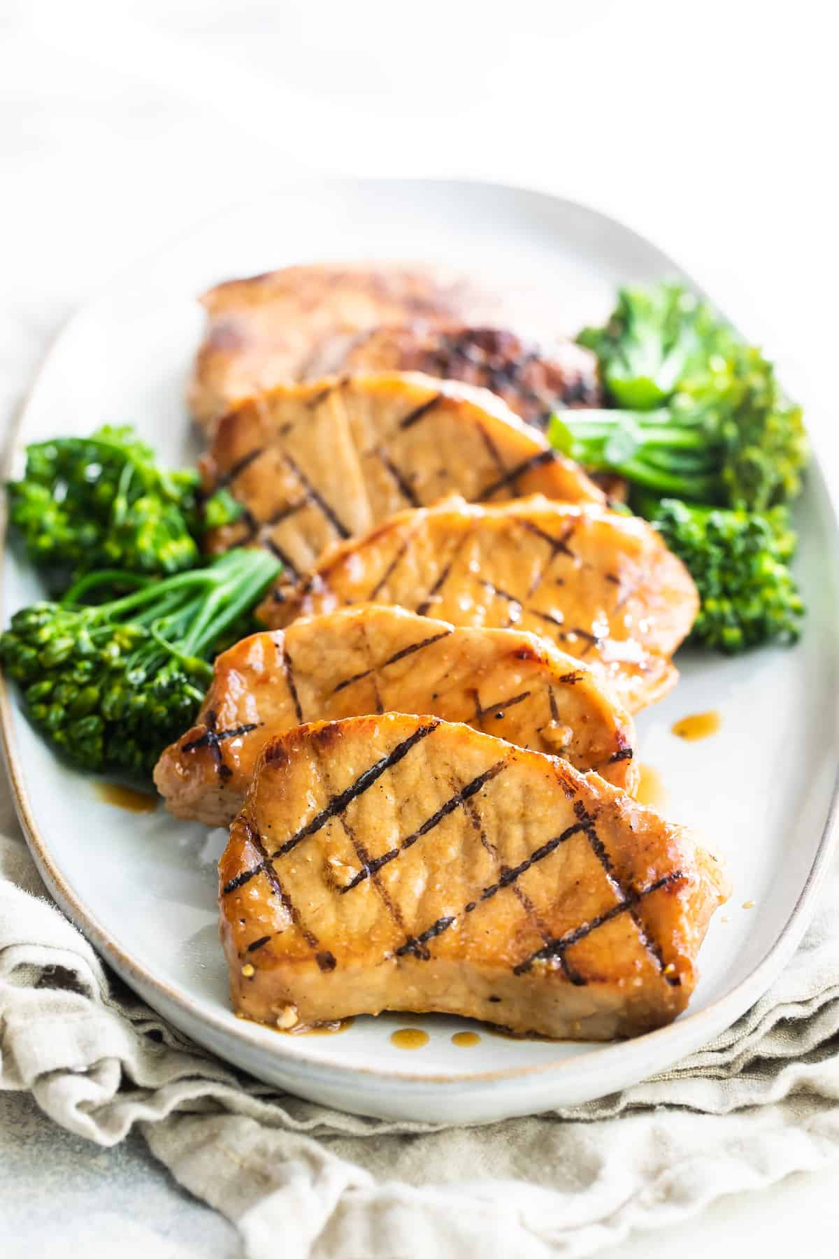 Six Honey Soy Pork Chops on a Plate with Broccoli on the Side