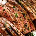 sliced london broil garnished with parsley