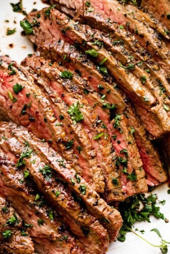 sliced london broil garnished with parsley