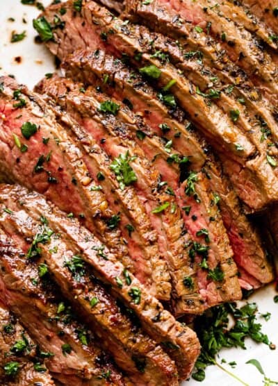 sliced london broil garnished with parsley