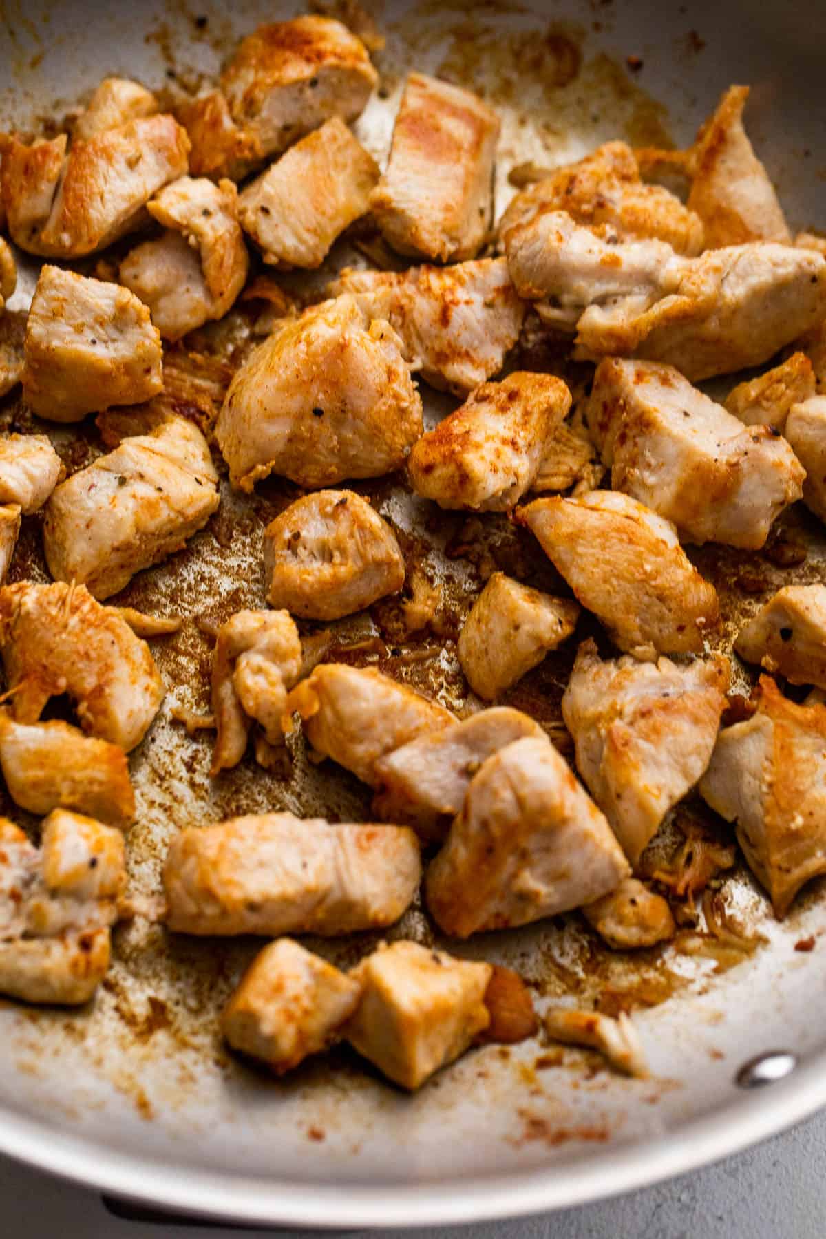 cooking chunks of chicken in a skillet