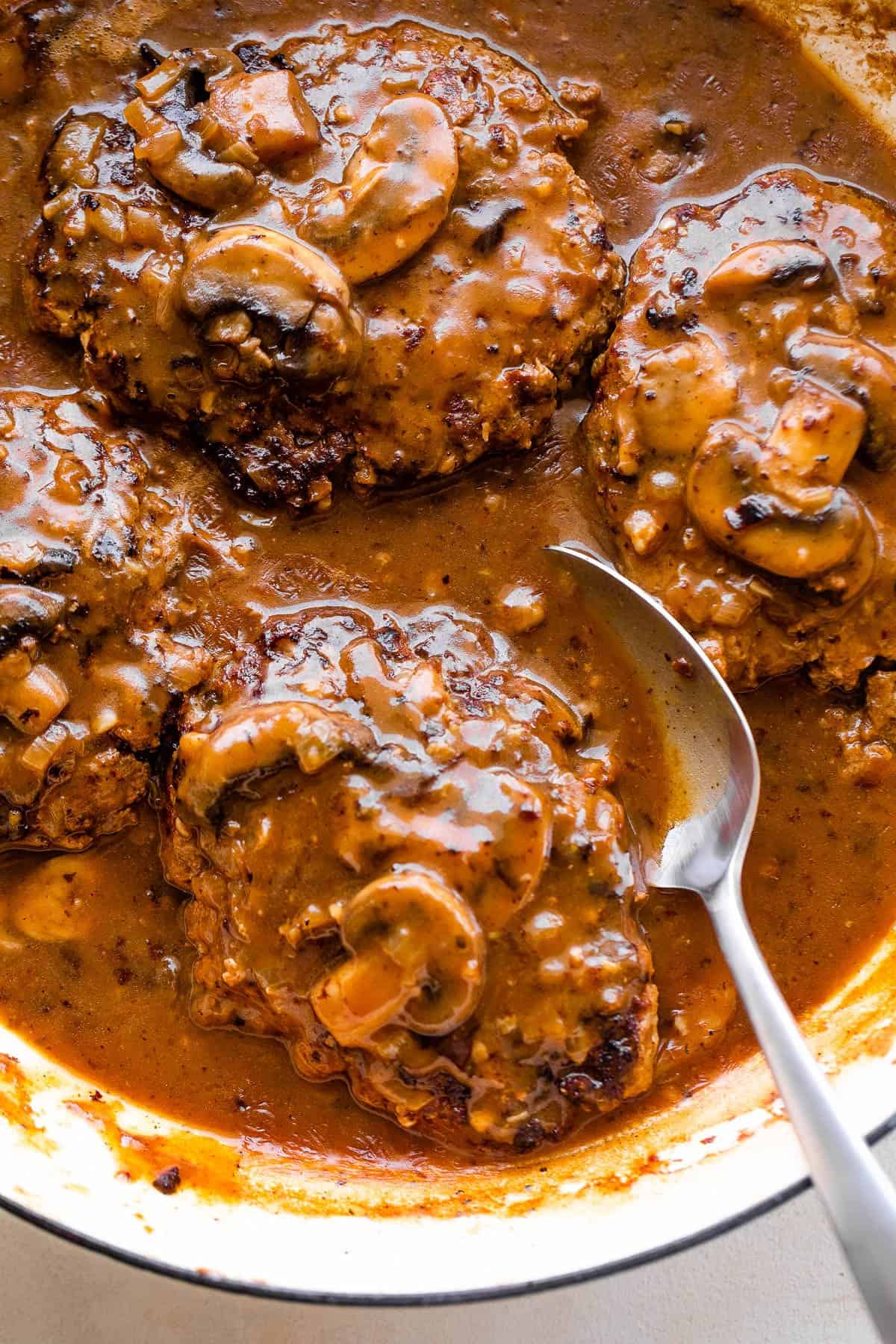 overhead shot of salisbury steaks cooking in mushroom gravy