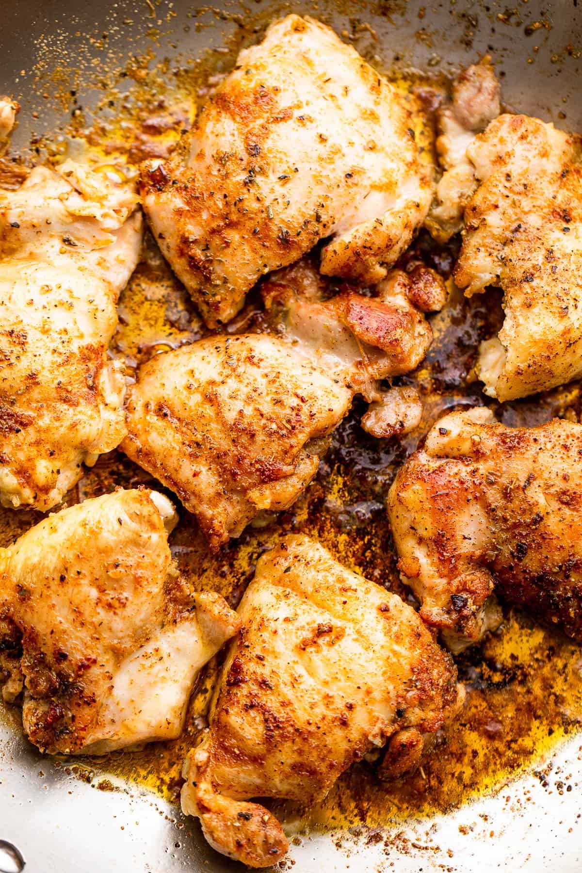 searing chicken thighs in a skillet